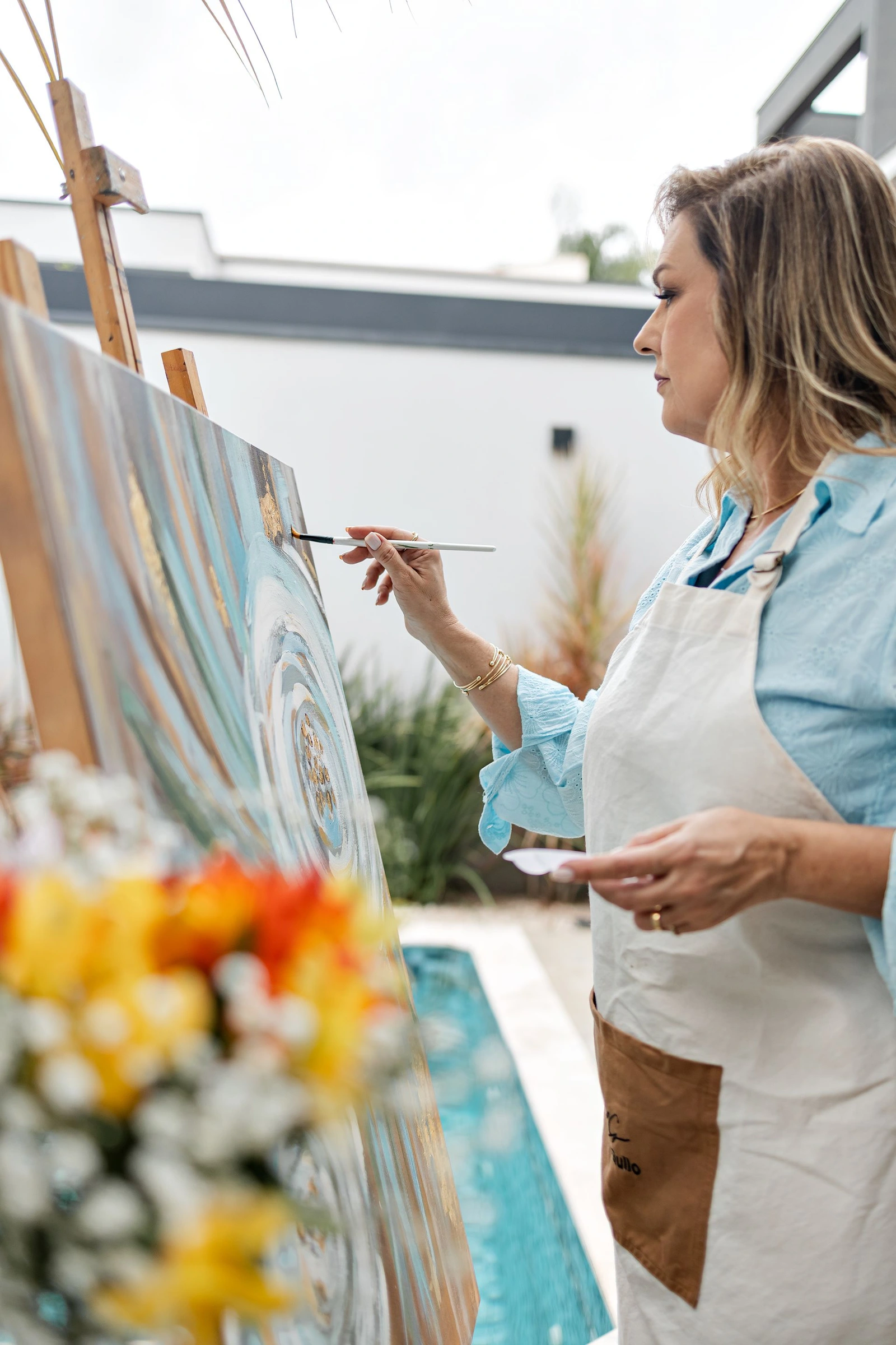 Helô Gullo pintando em um cavalete
